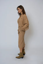 Load image into Gallery viewer, Woman wearing a tan sweater, tan long skirt and tan boots against a white background.