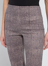 Load image into Gallery viewer, Close-up model wearing patterned pants and black top against a white background.
