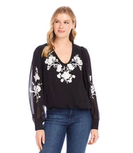 Load image into Gallery viewer, This elegant top will undoubtedly capture all the attention. Its stunning ivory floral embroidery on the black georgette fabric, is embellished with dazzling beads, while the sheer georgette blouson sleeves add extra sophistication. It's a versatile piece that can be dressed up or down for any occasion. A must-have for any wardrobe looking for an added touch of elegance.