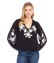 Load image into Gallery viewer, This elegant top will undoubtedly capture all the attention. Its stunning ivory floral embroidery on the black georgette fabric, is embellished with dazzling beads, while the sheer georgette blouson sleeves add extra sophistication. It's a versatile piece that can be dressed up or down for any occasion. A must-have for any wardrobe looking for an added touch of elegance.