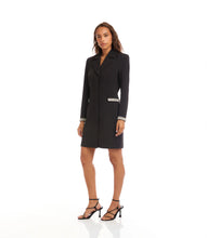 Load image into Gallery viewer, Woman wearing a black coat dress with rhinestone trim and black strappy heels against a white background.