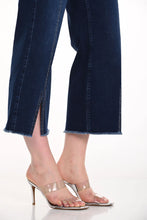 Load image into Gallery viewer, Close up of blue jeans with a slight crop and clear high-heeled sandals on a white background.