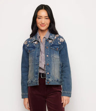 Load image into Gallery viewer, A woman modeling a blue denim jacket with floral embroidery and rhinestones on the shoulders, worn over a striped shirt and burgundy pants against a plain white background.
