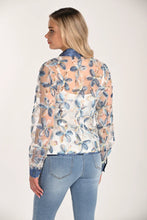 Load image into Gallery viewer, Woman wearing a floral lace blouse over a white cami and light blue jeans against a white background.