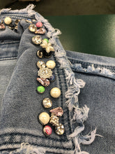Load image into Gallery viewer, There's really no need to wear jewelry when you wear this fabulous denim shacket. The classic denim shacket gets a refreshing update this season with eye-catching rhinestone embellishments in all sorts of colors and shapes meticulously set on the collar and pockets. Wear this statement piece and be prepared to get noticed!