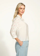Load image into Gallery viewer, This classic white shirt is elevated with beautifully embellished 3/4-length sleeves, adding a chic and modern twist. Designed with a spread collar and crafted from 100% cotton, it offers both comfort and elegance. Perfect for pairing with tailored trousers or casual denim, this versatile piece is a must-have for any occasion.