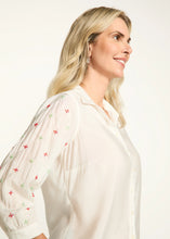Load image into Gallery viewer, This classic white shirt is elevated with beautifully embellished 3/4-length sleeves, adding a chic and modern twist. Designed with a spread collar and crafted from 100% cotton, it offers both comfort and elegance. Perfect for pairing with tailored trousers or casual denim, this versatile piece is a must-have for any occasion.