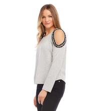 Load image into Gallery viewer, This cold-shoulder sweatshirt, masterfully crafted with detailed pearl adornments set against a backdrop of black, metallic gold, and cream tweed, brings an elegant flair to any ensemble. Perfect for errands or a relaxed evening, it provides an ideal mix of comfort and chic.