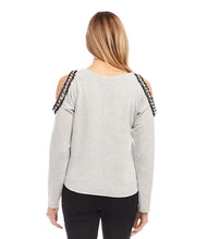 Load image into Gallery viewer, This cold-shoulder sweatshirt, masterfully crafted with detailed pearl adornments set against a backdrop of black, metallic gold, and cream tweed, brings an elegant flair to any ensemble. Perfect for errands or a relaxed evening, it provides an ideal mix of comfort and chic.