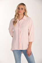 Load image into Gallery viewer, Woman wearing a light pink sequined shirt and blue jeans on a white background.