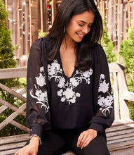 Load image into Gallery viewer, This elegant top will undoubtedly capture all the attention. Its stunning ivory floral embroidery on the black georgette fabric, is embellished with dazzling beads, while the sheer georgette blouson sleeves add extra sophistication. It's a versatile piece that can be dressed up or down for any occasion. A must-have for any wardrobe looking for an added touch of elegance.