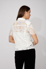 Load image into Gallery viewer, Woman wearing an off-white blouse with heart embroidery and rhinestone heart buttons and black pants against a white background.