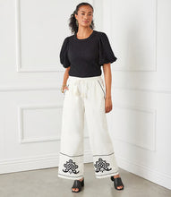 Load image into Gallery viewer, Redefine casual sophistication with the Karen Kane Embroidered Drawstring Ankle Pants. Featuring a timeless design and intricate embroidery, these pants bring a touch of refinement to your everyday wardrobe. The comfortable drawstring waist, functional pockets, and airy wide-leg fit make them as practical as they are stylish. Perfect for adding a chic twist to any look, from relaxed afternoons to polished evenings.