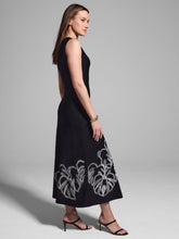 Load image into Gallery viewer, The Evelina Embroidered Knit Twirl Dress by Nic & Zoe is a stunning black with white detailing, fit-and-flare midi dress designed for effortless elegance. It features a round neckline, sleeveless design, and straight hem, making it a versatile choice for various occasions. The embroidered twirl knit fabrication adds a touch of sophistication, while the pullover construction ensures easy wear while the super-soft, drapey viscose knit creates a refined, dressy feel.