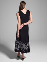 Load image into Gallery viewer, The Evelina Embroidered Knit Twirl Dress by Nic & Zoe is a stunning black with white detailing, fit-and-flare midi dress designed for effortless elegance. It features a round neckline, sleeveless design, and straight hem, making it a versatile choice for various occasions. The embroidered twirl knit fabrication adds a touch of sophistication, while the pullover construction ensures easy wear while the super-soft, drapey viscose knit creates a refined, dressy feel.