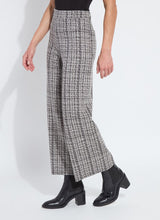 Load image into Gallery viewer, Model wearing lush tweed textured wide-leg pants, black top and black boots against a white background.