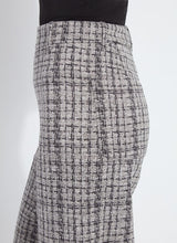 Load image into Gallery viewer, Close- up of the side of lush tweed textured wide-leg pants and black top worn by model against a white background.