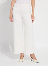 Load image into Gallery viewer, Model wearing chalk white wide-leg pants and white heels against a light gray background.