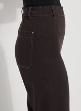 Load image into Gallery viewer, Crafted from 4-way stretch Knit Denim, these jeans boast a high-waisted, wide-leg cut with a concealed patented waistband, back patch pockets adorned with gunmetal studs, belt loops, and topstitching. The Erin High Waist Wide Leg Denim offers an extra-wide leg without side seams, presenting a cropped, ankle-length design with a raw-edge hem that can be easily shortened.