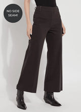 Load image into Gallery viewer, Crafted from 4-way stretch Knit Denim, these jeans boast a high-waisted, wide-leg cut with a concealed patented waistband, back patch pockets adorned with gunmetal studs, belt loops, and topstitching. The Erin High Waist Wide Leg Denim offers an extra-wide leg without side seams, presenting a cropped, ankle-length design with a raw-edge hem that can be easily shortened.