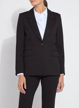 Load image into Gallery viewer, Woman wearing a black suit with white blouse against a white background.