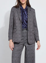 Load image into Gallery viewer, Woman wearing a grey checkered suit with a blue top posing against a white background.