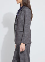 Load image into Gallery viewer, Woman wearing a grey checkered suit with a blue top posing against a white background.