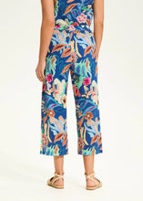 Load image into Gallery viewer, Step into comfort and flair with these contrasting floral pull-on pants. Designed for effortless style, these wide-leg cropped pants feature eyelet detailing and a vivid camo floral print, making them a standout piece in any wardrobe.