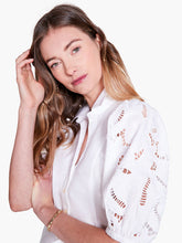 Load image into Gallery viewer, An embroidered top loaded with detail, this shirt is a must-have for casual denim looks and elevated outfits alike. Signature embroidery details and negative space on the puff sleeves add texture and interest to your look. Elastic at the short sleeve openings add extra shape. Wear it with the collar popped to add some attitude. With a classic button front and a hem designed to sit at the hip. Color- Paper white. Regular fit. Shirt collar. Short sleeve.