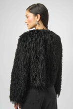 Load image into Gallery viewer, Woman wearing a black faux fur boxy jacket, black jeans and silver earrings against a white background.