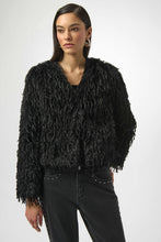 Load image into Gallery viewer, Woman wearing a black faux fur boxy jacket and black studded jeans against a white background.