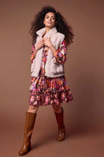 Load image into Gallery viewer, Experience the pinnacle of comfort with this opulent sleeveless vest, made from sumptuous faux fur. Perfect for transitional weather, it boasts an easy zip-up front, a versatile 24-inch length, and a high mock neck collar for protection against brisk breezes. Equipped with puffy patch pockets, this vest combines functionality with fashionable flair, promising ultimate comfort and understated elegance.