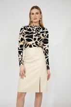 Load image into Gallery viewer, Woman wearing a patterned blouse and bone colored pencil skirt against a white background.