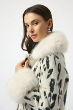 Load image into Gallery viewer, Woman wearing a black and white animal print coat with white fur trim against a white background.