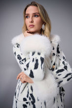 Load image into Gallery viewer, Woman wearing a white coat with black animal pattern and fur trim against a gray background.