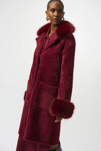 Load image into Gallery viewer, Woman wearing a burgundy coat with fur trim against a white background.