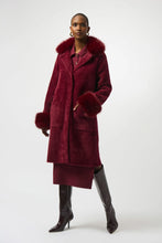 Load image into Gallery viewer, Woman wearing a burgundy coat with fur trim and tall black boots against a white background.