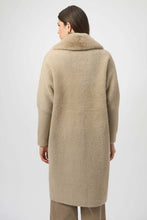Load image into Gallery viewer, Woman wearing a warm taupe long coat and taupe jeans against a white background.