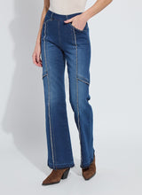 Load image into Gallery viewer, Model wearing fringe blue jeans and brown suede boots against a white background.