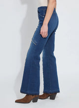 Load image into Gallery viewer, Model wearing fringe blue jeans and brown suede boots against a white background.