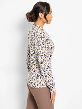 Load image into Gallery viewer, Woman wearing a cheetah print V-neck sweater and taupe pants against a white backdrop.