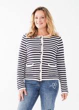 Load image into Gallery viewer, Experience comfort and style with this essential addition for a sophisticated appearance. Wear it unbuttoned over your preferred top or buttoned up for a refined look. The classic white and navy stripes offer a timeless appeal. Easily dressed up or down for any occasion. Color- White and navy stripe. Front button closure. Round neck. Long sleeves.
