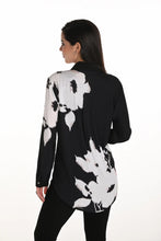Load image into Gallery viewer, Woman wearing a black and white floral blouse and black leggings against a white background.