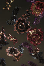 Load image into Gallery viewer, Close-up photo of multi-color floral sequins on a black background.