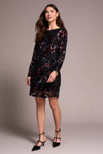 Load image into Gallery viewer, Woman wearing a black and floral sequin dress and black heels against a neutral background.