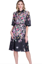 Load image into Gallery viewer, Woman wearing a floral dress with a white background.