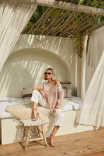 Load image into Gallery viewer, Nothing embodies spring quite like flowers, and our Fallon top is the perfect spring style with its textured raised floral design. This chic sweater showcases flowers adorned with shimmering gold embellishments, ensuring you stand out in any crowd. The lightweight blush fabric has a slight sheen, adding an elevated touch to your look. With its crewneck and versatile style, it's perfect for both casual outings and special occasions.