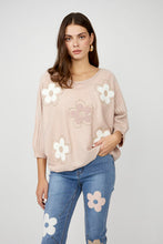 Load image into Gallery viewer, Nothing embodies spring quite like flowers, and our Fallon top is the perfect spring style with its textured raised floral design. This chic sweater showcases flowers adorned with shimmering gold embellishments, ensuring you stand out in any crowd. The lightweight blush fabric has a slight sheen, adding an elevated touch to your look. With its crewneck and versatile style, it's perfect for both casual outings and special occasions.