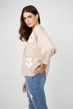 Load image into Gallery viewer, Nothing embodies spring quite like flowers, and our Fallon top is the perfect spring style with its textured raised floral design. This chic sweater showcases flowers adorned with shimmering gold embellishments, ensuring you stand out in any crowd. The lightweight blush fabric has a slight sheen, adding an elevated touch to your look. With its crewneck and versatile style, it's perfect for both casual outings and special occasions.