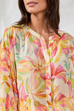 Load image into Gallery viewer, Woman wearing a colorful floral blouse against a white background.